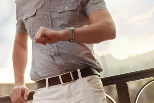 man looking at wristwatch